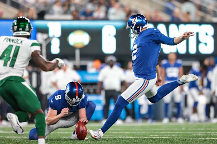 Aug 14, 2021; East Rutherford, New Jersey, USA; New York Giants punter Ryan Santoso (2) kicks an extra point as New York Giants punter Riley Dixon (9) holds and New York Jets cornerback Jason Pinnock (41) defends during the second half at MetLife Stadium.